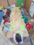 Dzieci z grupy Kropelki przyklejaja do kartki papierowe figury